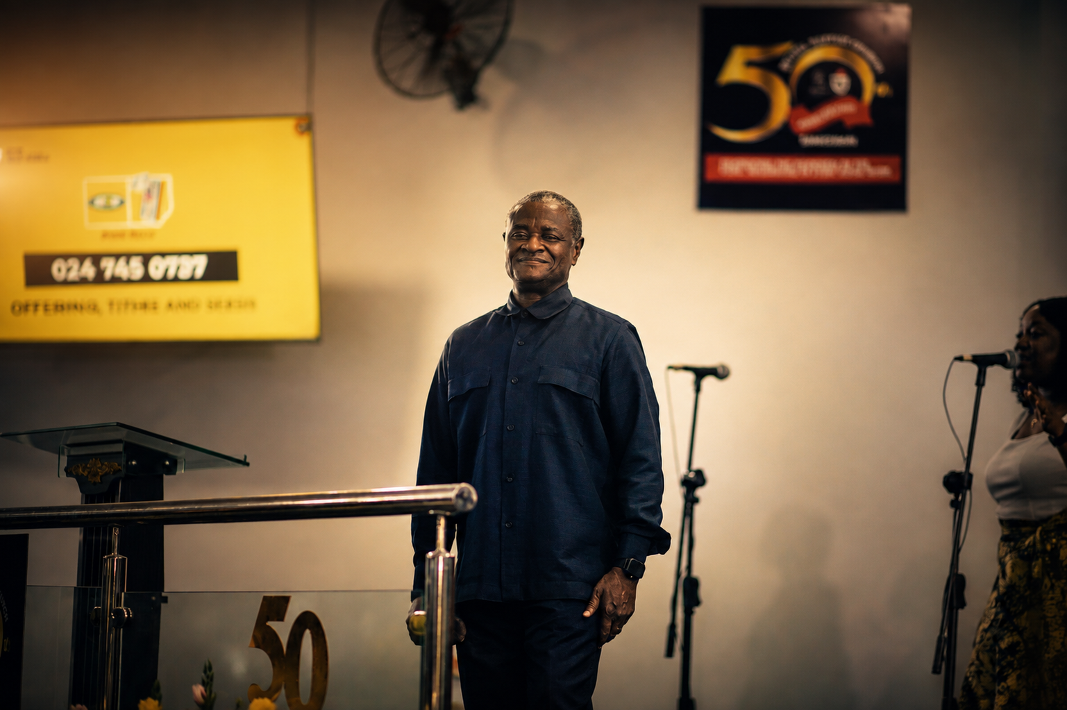 A guest minister smiling as he arrives at the platform