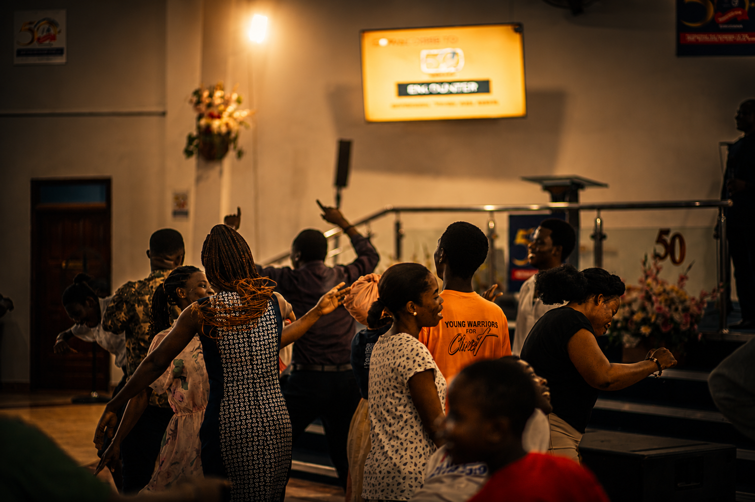Congregation dancing joyfully during an Encounter service