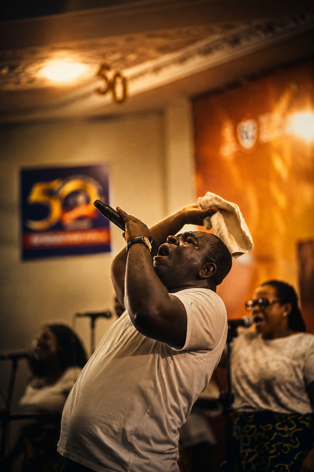 A worship leader singing passionately with head lifted